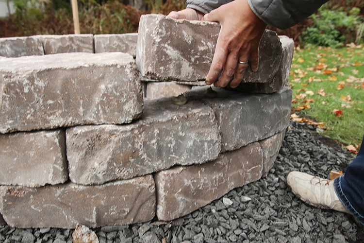 Setting stones on a fire pit.