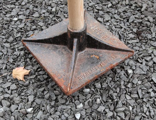 Tamp down crushed stone to create a firm base.